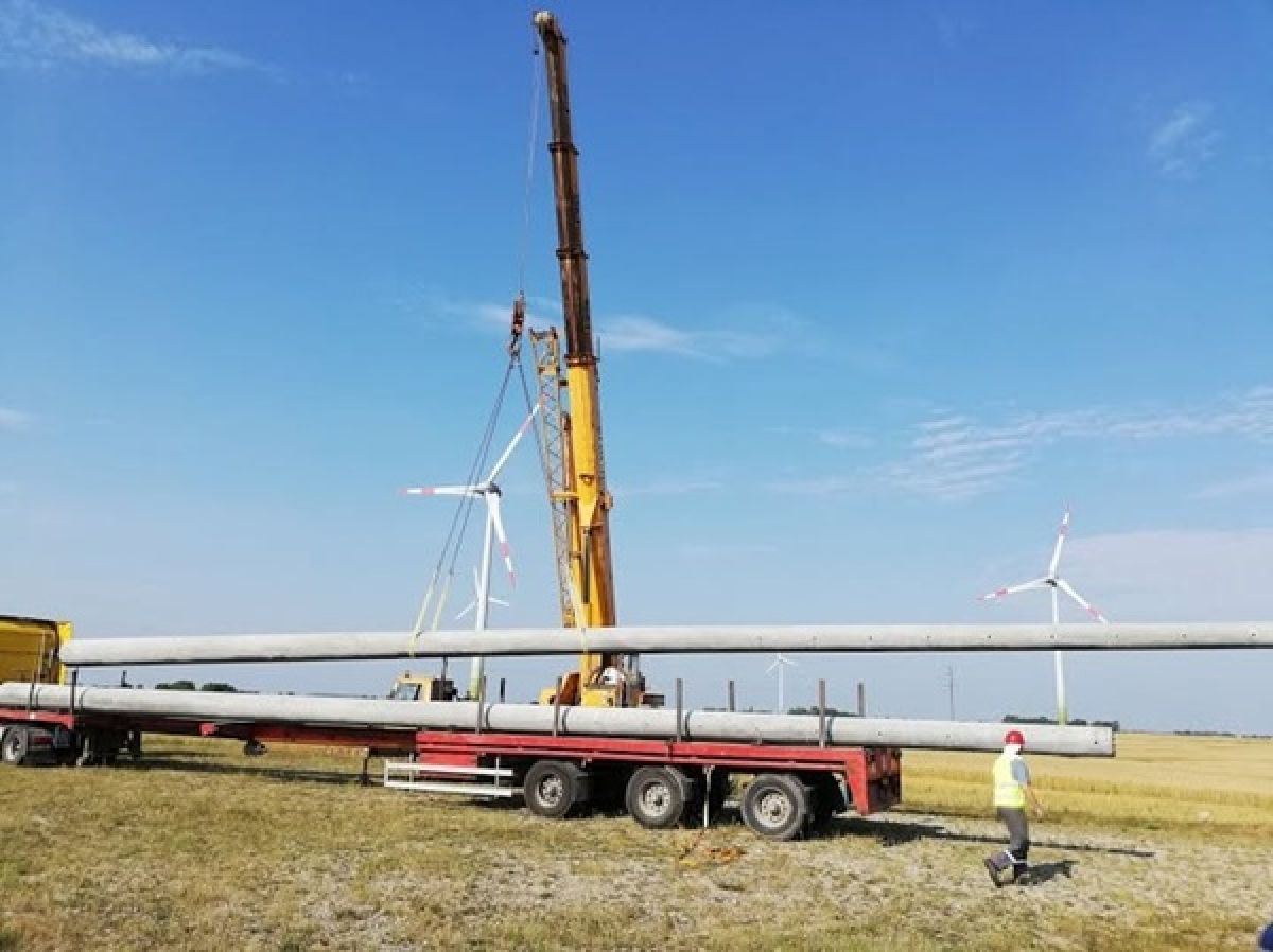 Kranų Bankas teleskopinis kranas kelia vamzdžius vėjo elektrinių aik&scaron;telėje